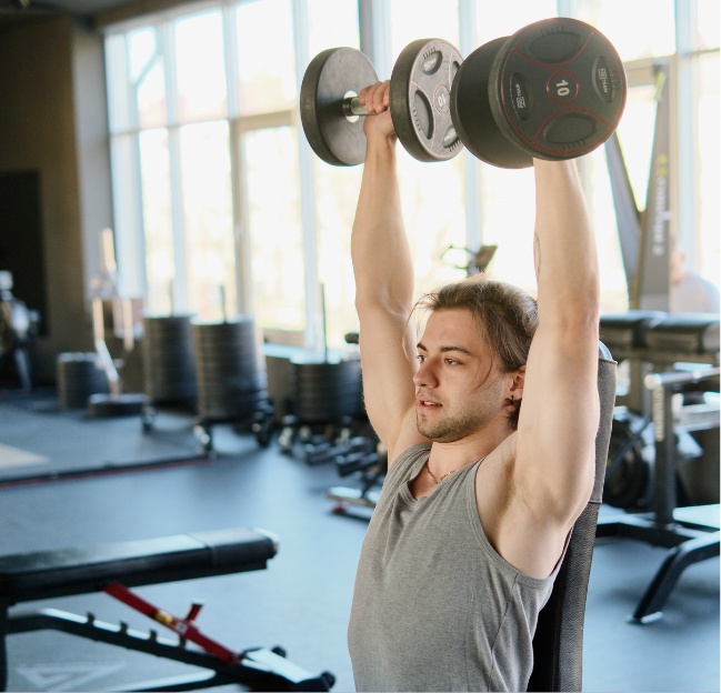 Man lifting dumbbells overhead